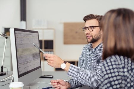 Man and woman working together at computer